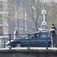Google streetview car on the bridge watching a house go past