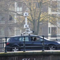 Google streetview car on the bridge watching a house go past
