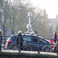 Google streetview car on the bridge watching a house go past