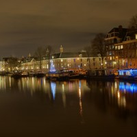 Houseboats on the Amstel River along the Hermitage museum, decorated for Christmas