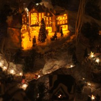 Tiny Christmas village in someone's living room window.
