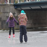 Neighbors skating on the Nieuwe Prinsengracht