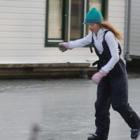 Neighbors skating on the Nieuwe Prinsengracht