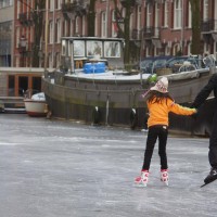 Neighbors skating on the Nieuwe Prinsengracht