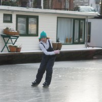 Neighbors skating on the Nieuwe Prinsengracht