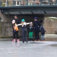 Neighbors skating on the Nieuwe Prinsengracht