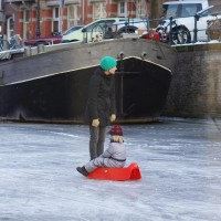 Neighbors skating on the Nieuwe Prinsengracht