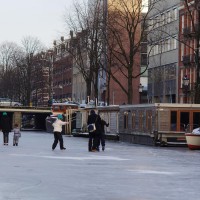 Neighbors skating on the Nieuwe Prinsengracht