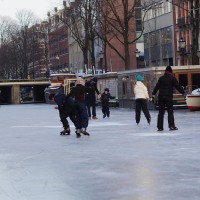 Neighbors skating on the Nieuwe Prinsengracht