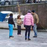 Neighbors skating on the Nieuwe Prinsengracht