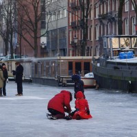 Neighbors skating on the Nieuwe Prinsengracht