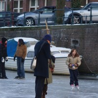 Neighbors skating on the Nieuwe Prinsengracht