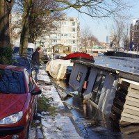 Neighbors gathering around to take pictures and discuss the tragedy.