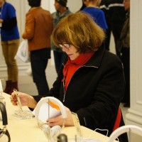 Oma's kickin some beats on an iPod, checkin the Dre' Headphones.