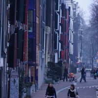 Shutters and beautiful dutch girls on bikes going home from shopping.