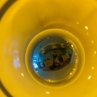 Self-portrait in a lightbulb on the ceiling of the noodle shop.