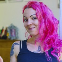 Rosanna the tattoo artist in her shop doorway