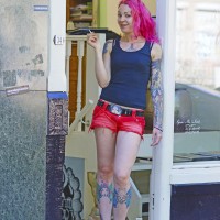 Rosanna the tattoo artist in her shop doorway