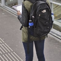 Pretty girl waiting on the train platform with her iPad