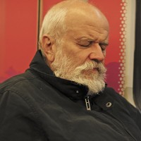 Handsome bearded man texting on the subway