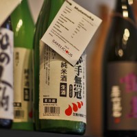 Some huge bottles of Sake on the top shelf