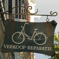 Hand-painted sign outside a custom bicycle shop.