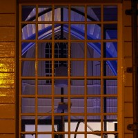 Gazing through a window of the Amstelkerk (Amstel Church) at night.