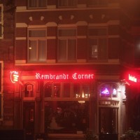 Rembrandt Corner Café (next to Rembrandt House) glowing red in the fog