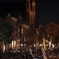 Scooters in the foreground of the Krijtberg Catholic church on the Singel canal